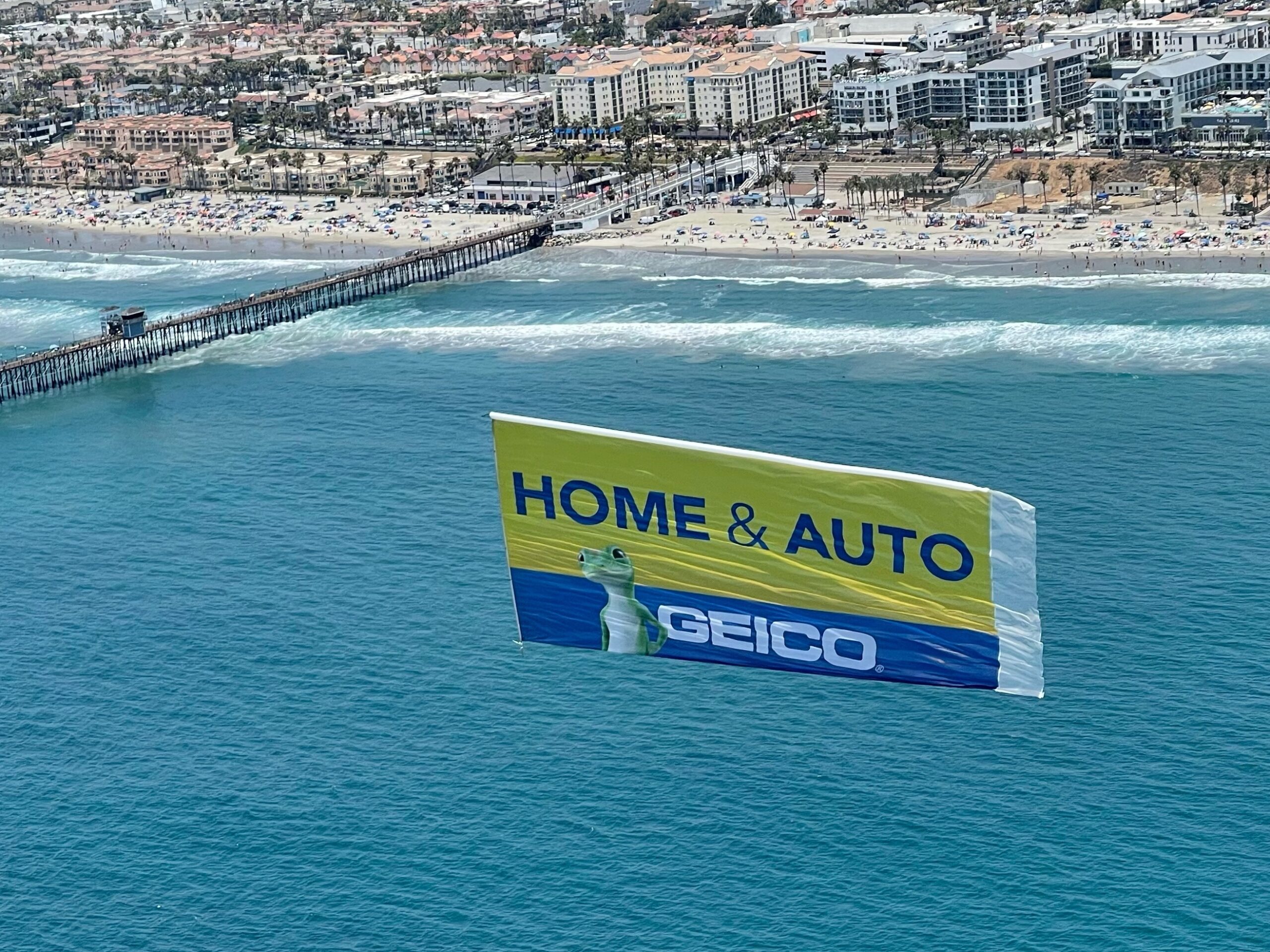 Geico Aerial Billboard flies above San Diego beaches